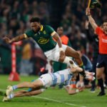 Argentina's wing Mateo Carreras (L) tackles South Africa's centre Lukhanyo Am during the Rugby Championship final-round match between South Africa and Argentina at Ellis Park in Johannesburg on July 29, 2023.