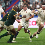 England's openside flanker Tom Curry (R) runs with the ball during the France 2023 Rugby World Cup semi-final match between England and South Africa at the Stade de France in Saint-Denis, on the outskirts of Paris, on October 21, 2023. (Photo by Anne-Christine POUJOULAT / AFP)