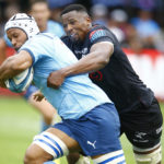 DURBAN, SOUTH AFRICA - DECEMBER 31: Sikhumbuzo Notshe of the Cell C Sharks tackling Nizaam Carr of the Vodacom Bulls during the United Rugby Championship match between Cell C Sharks and Vodacom Bulls at Hollywoodbets Kings Park Stadium on December 31, 2022 in Durban, South Africa. (Photo Mandatory Credit Steve Haag/Gallo Images)