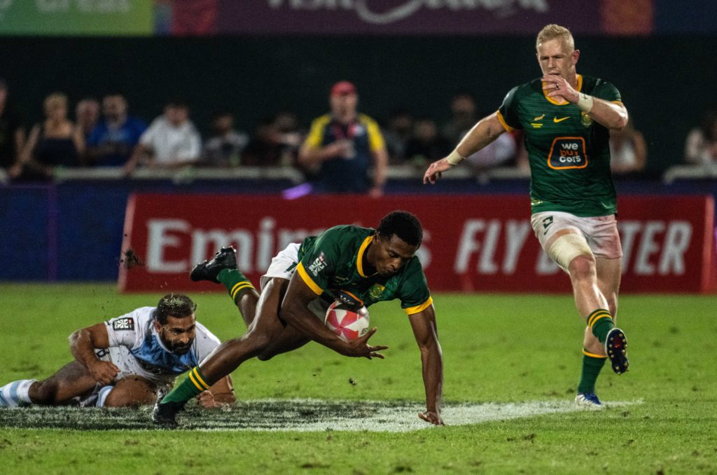 DUBAI, UNITED ARAB EMIRATES - DECEMBER 3: Masande Mtshali of South Africa falls with the ball after a tackle in the final against Argentina during the HSBC SVNS rugby tournament on December 3, 2023 in Dubai, United Arab Emirates.