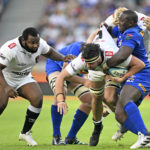 Emile van Heerden of the Sharks is tackled by Sti Sithole and Adre Smith of the Stormers during the 2023 United Rugby Championship game between the Stormers and Sharks at Cape Town Stadium on 30 December 2023 ©Ryan Wilkisky/BackpagePix