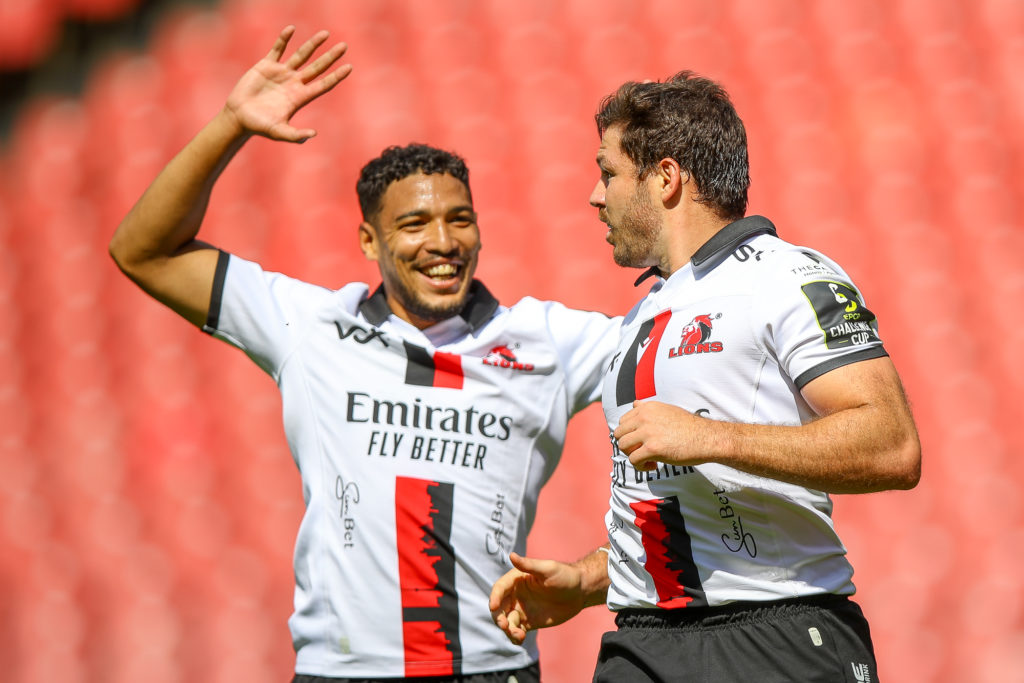 JOHANNESBURG, SOUTH AFRICA - JANUARY 21: Gianni Lombard of the Emirates Lions congratulates Marius Louw (c) of the Emirates Lions afterbscoring his try during the EPCR Challenge Cup match between Emirates Lions and Ospreys at Emirates Airlines Park on January 21, 2024 in Johannesburg, South Africa. (Photo by Gordon Arons/Gallo Images)