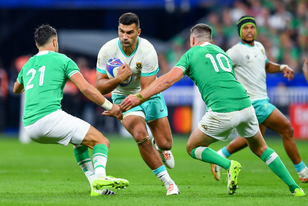 PARIS, FRANCE - SEPTEMBER 23: Damian de Allende of South Africa is tackled by Ronan Kelleher and Jonathan Sexton of Ireland during the Rugby World Cup France 2023 match between South Africa and Ireland at Stade de France on September 23, 2023 in Paris, France. (Photo by Franco Arland/Quality Sport Images/Getty Images)