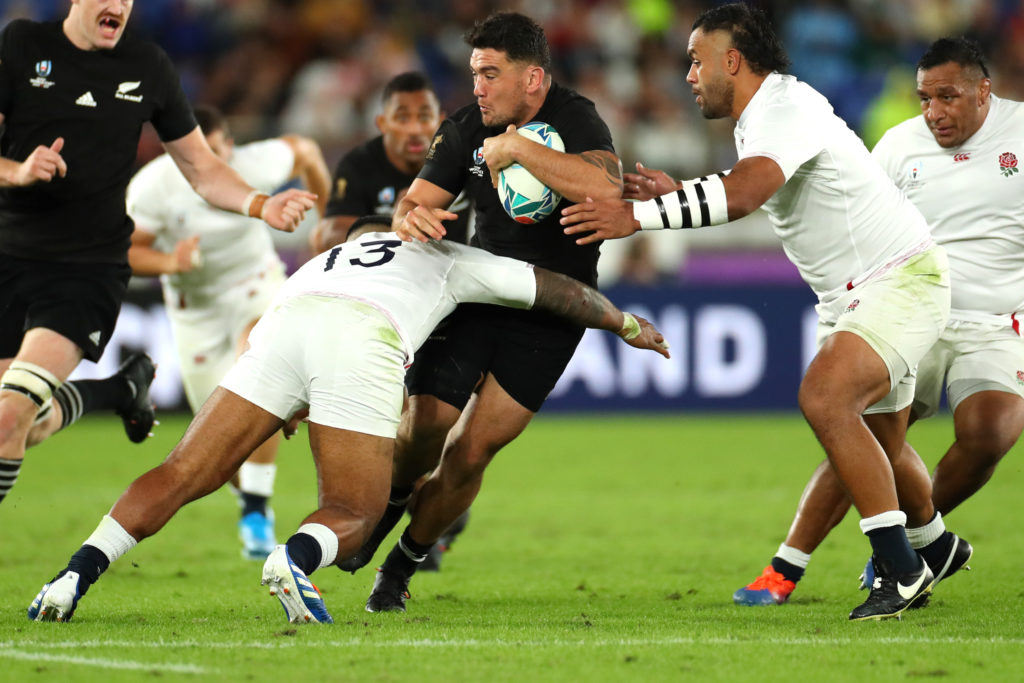 YOKOHAMA, JAPAN - OCTOBER 26: Codie Taylor of New Zealand is tackled by Manu Tuilagi of England during the Rugby World Cup 2019 Semi-Final match between England and New Zealand at International Stadium Yokohama on October 26, 2019 in Yokohama, Kanagawa, Japan. (Photo by Hannah Peters/Getty Images)